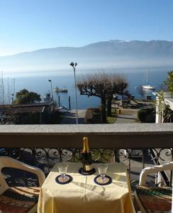 a bottle of wine sitting on a table on a balcony at Incanto Sublime in Verbania