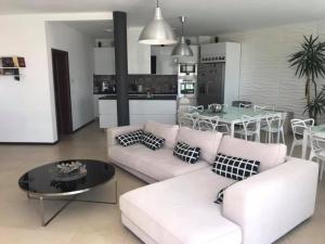 a living room with a white couch and a table at Villa St Anna in Sozopol