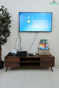 a flat screen tv sitting on top of a coffee table at A2JSuites Bedroom Taal View Luxury Smart Home Suite Near Skyranch in Tagaytay
