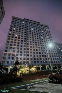 a large white building with a parking lot at night at A2JSuites Bedroom Taal View Luxury Smart Home Suite Near Skyranch in Tagaytay