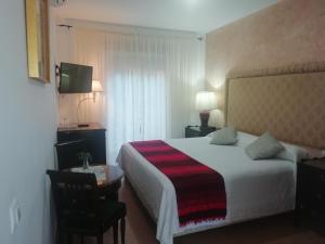 Postel nebo postele na pokoji v ubytování Hostal Alhaja Playa