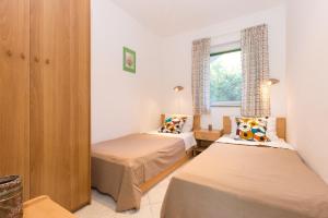 Posteľ alebo postele v izbe v ubytovaní Apartments Krajina