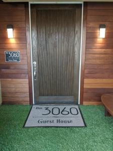 a guest house door with a guest house sign on it at The 3060 Guest House in Atlanta