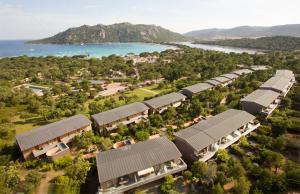 an aerial view of a resort with houses and the water at Résidence Cala Sultana in Porto-Vecchio