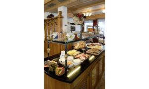 a buffet line with many different types of food at Hotel Lasalt in Ischgl
