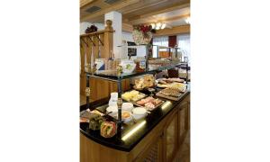 a buffet line with many different types of food at Hotel Lasalt in Ischgl