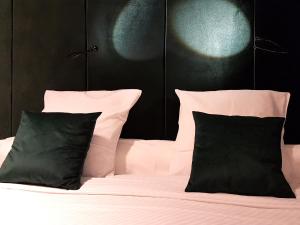 a bedroom with a bed with black and white pillows at Goodnight Antwerp in Antwerp