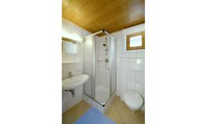 a bathroom with a shower and a sink and a toilet at Hotel Lasalt in Ischgl +12 photos