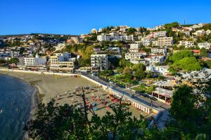 a view of a beach with buildings and a city at Apartmani Djurovic in Ulcinj