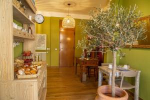 a dining room with a table and a potted tree at il Palchetto B&B di Charme e Design in Palermo