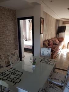 a living room with a table and a couch at FamilyConfort Saidia in Saïdia