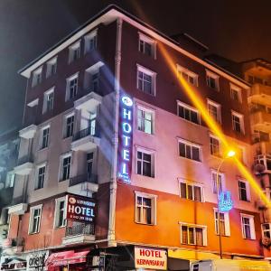 a hotel with a neon sign on the side of it at Hotel Kervansaray in Erzurum