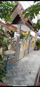 a chair sitting on a patio next to a fence at WaruneeVilla in Nong Prue