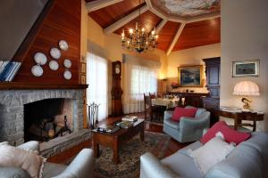 a living room with couches and a fireplace at VILLA BELLI - Luxury Villa with saltwater SWIMMINGPOOL in Agnino