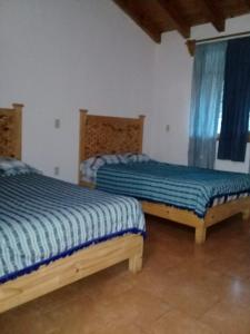 Postel nebo postele na pokoji v ubytování Cabaña "La Matera"