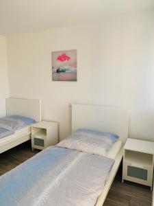 Ένα ή περισσότερα κρεβάτια σε δωμάτιο στο IG-Apartments