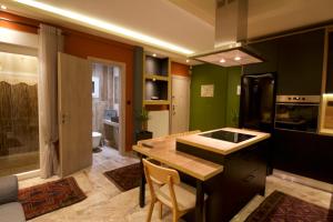 a kitchen with green walls and a wooden counter top at Eros - Luxurious Apartment in Thessaloniki
