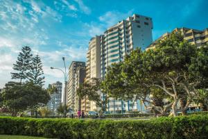 a city with tall buildings and a park at Oceanfront Penthouse in Miraflores in Lima