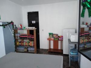 a room with a refrigerator and shelves of drinks at Hotel Juarez in Cuernavaca