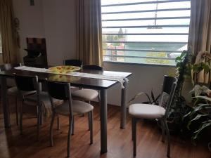 una mesa de comedor y sillas en una habitación con ventana en Calafate Vision en El Calafate