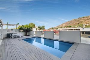 a swimming pool on the roof of a building at Central Kensington Apartments in Townsville