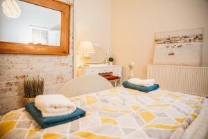 a room with a bed with towels on top of it at Cosy Apartment in Safe Area in Liverpool