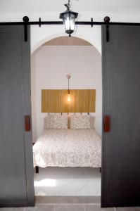 a bedroom with a bed in a room with an open door at Villa Tranquilidad with amazing private terrace and heated pool in Charco del Palo