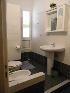 a bathroom with a toilet and a sink at Vecchie Mura in Varazze