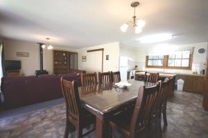 a dining room and living room with a table and chairs at Halls Gap Log Cabins in Halls Gap