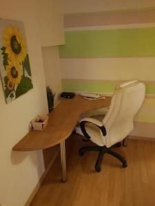 an office with a desk with a chair and a picture at КВАРТИРА ЦЕЛИКОМ 3-rooms apartment in Tallinn