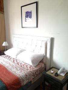Un pat sau paturi într-o cameră la Apart Corrientes Broadway