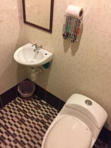 a bathroom with a toilet and a sink at Ilhamku Inn in Kampong Kemaman +13 photos