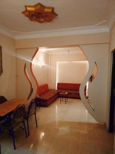 a living room with a couch and a table and chairs at شمس أسوان شقة شعبية رخيصة أمان in Aswan