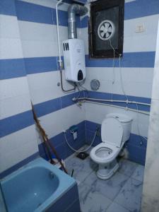 a blue and white bathroom with a toilet and a sink at شمس أسوان شقة شعبية رخيصة أمان in Aswan