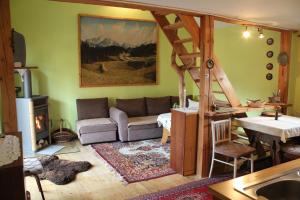 a living room with a couch and a table at Marko Apartmány in Oščadnica