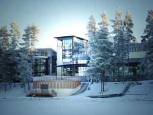 a building in the snow with trees in front of it at Kuortaneen Urheiluopisto in Kuortane