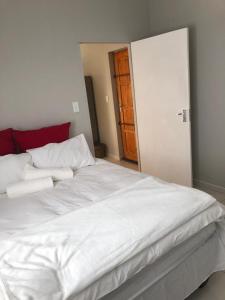 1 cama blanca grande con 2 almohadas encima en Tuna Self Catering, en Swakopmund
