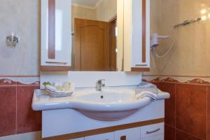 a bathroom with a sink and a mirror at Sea View Resorts & Spa in Karfas