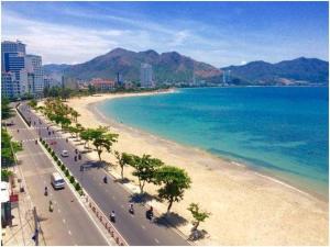 a view of a beach with trees and the ocean at Wonderland 24H Apartments in Nha Trang