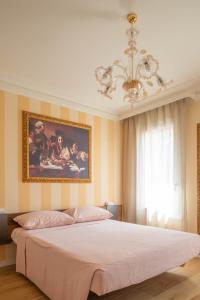 una camera da letto con un grande letto e un dipinto sul muro di Little House a Campo San Martino