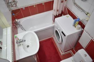 a bathroom with a sink and a toilet and a tub at 2 комнатные апартаменты на Габдуллина 46а in Kokshetau