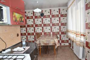 a kitchen with a table and a dining room at 2 комнатные апартаменты на Габдуллина 46а in Kokshetau