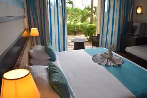 Ένα ή περισσότερα κρεβάτια σε δωμάτιο στο Pearle Beach Resort & Spa