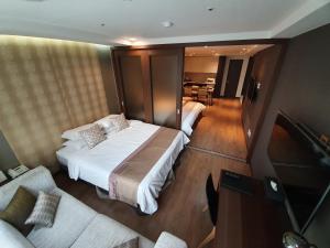 a bedroom with a bed and a living room at Ocloud Hotel Gangnam in Seoul