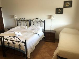 a bedroom with a bed with white sheets and pillows at Il Cuccaro B&B-Bike Friendly in Eboli