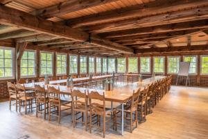a large room with a long table and chairs at Landhaus Haverbeckhof in Niederhaverbeck