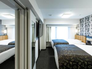En eller flere senger på et rom på APA Hotel Kyoto Ekihigashi
