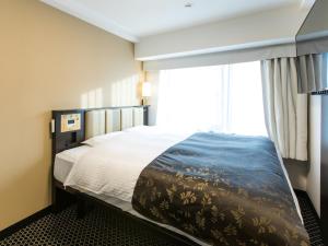 Postel nebo postele na pokoji v ubytování APA Hotel Kyoto Ekihigashi + 37 fotografií