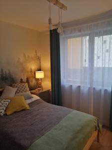 Ένα ή περισσότερα κρεβάτια σε δωμάτιο στο Apartamenty KDN Szczyrk