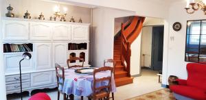 a dining room with a table and a red chair at La Dimanche in Reuil-sur-Marne